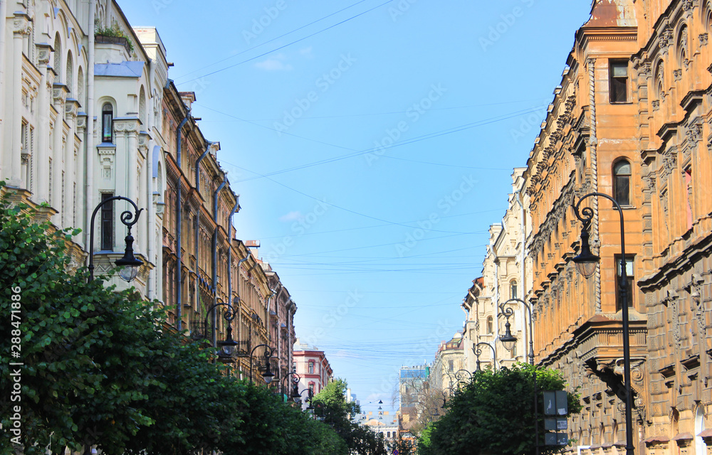 Historic old house fronts on city street in Saint Petersburg, Russia. Sunny summer day view with ornamental building facades facing each other on cozy narrow street 