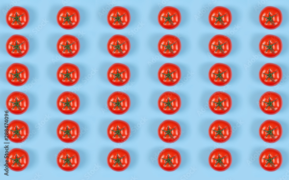 Colorful pattern of red fresh tomatos on blue background. Top view. Flat lay . Colorful pattern of red fresh tomatos on blue background. Top view. Flat lay .