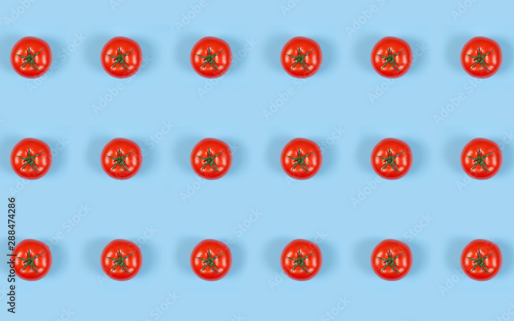 Colorful pattern of red fresh tomatos on blue background. Top view. Flat lay . Colorful pattern of red fresh tomatos on blue background. Top view. Flat lay .