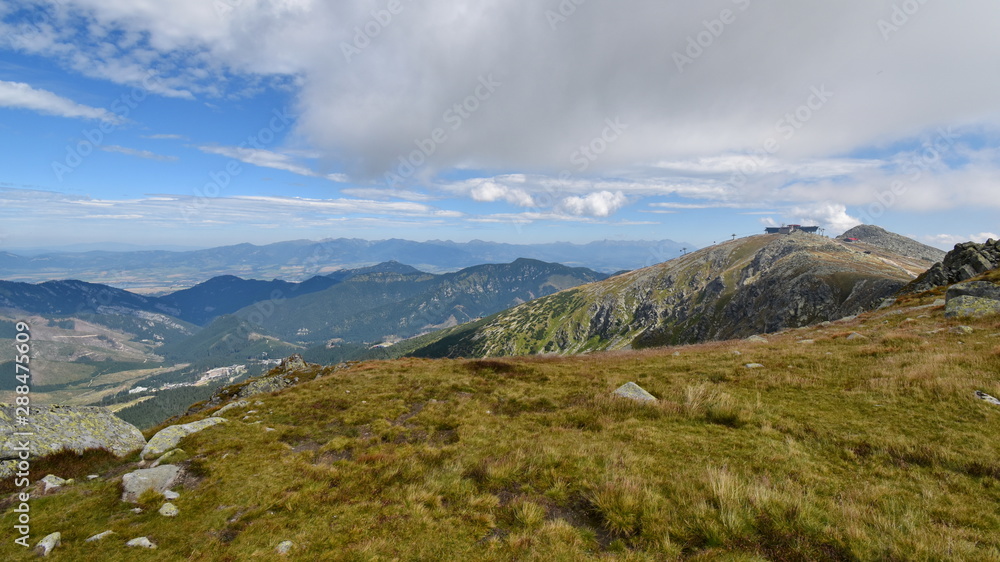 View of the top of Mount Chopok on a sunny day in the ski resort Jasna, Low Tatras, Slovakia. High Tatras in the background.