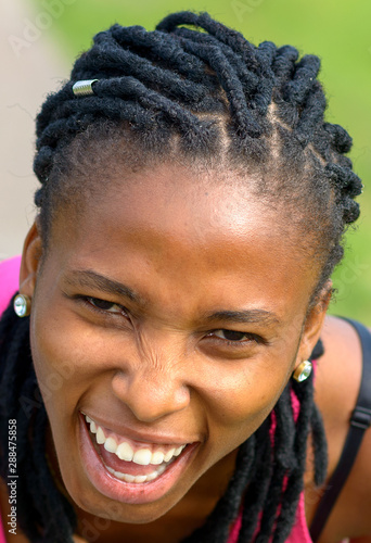 Sporty young African woman laughing at the camera