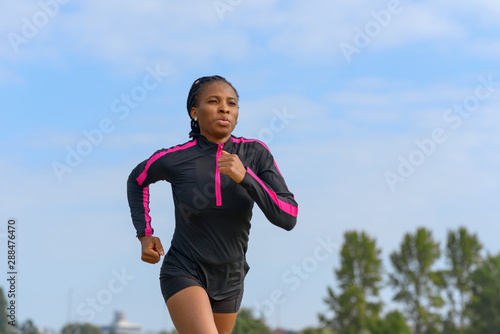 Fotografie Athletic African woman out for her daily jog