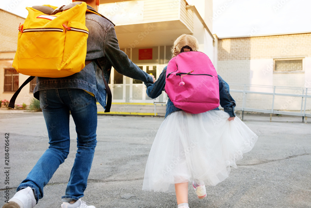 Boy with girl hold hand run to school