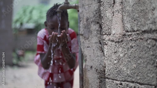 Human Rights Issues, African Black Ethnicity Girl Woman Drinks Fresh Clean Water from Tap