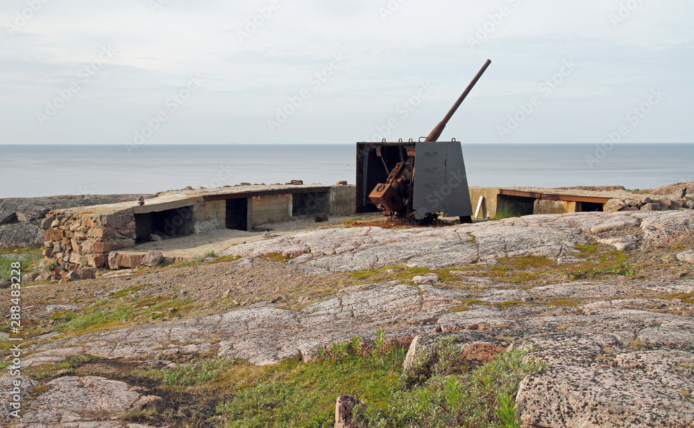 Soviet time artillery at the shore of Barents Sea nearby Teriberka
