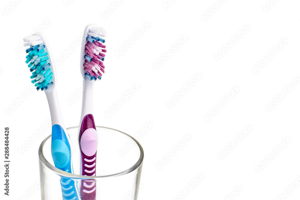 Two new toothbrush in glass isolated on a white background Two new toothbrush in glass isolated on a white background
