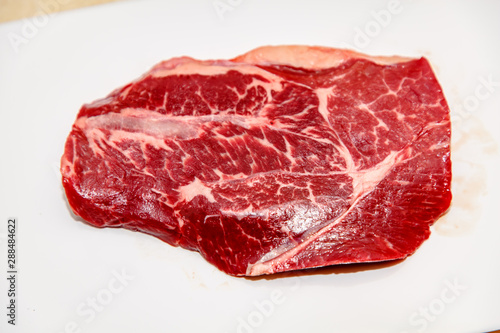 Top blade steak marbled beef on white background