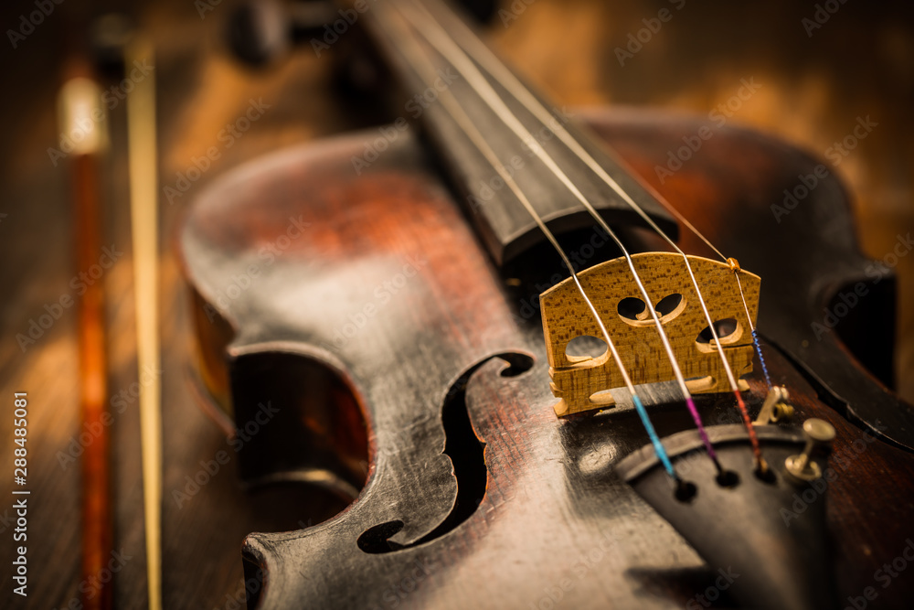 Fototapeta premium Detail of old violin and bow in vintage style