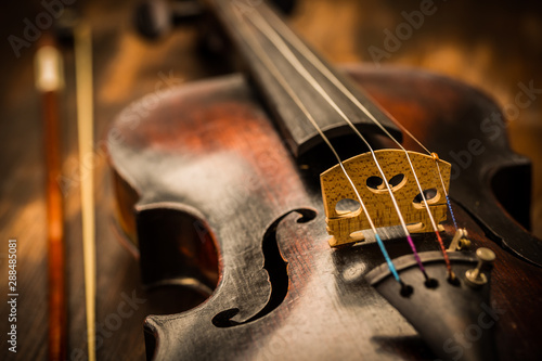 Detail of old violin and bow in vintage style
