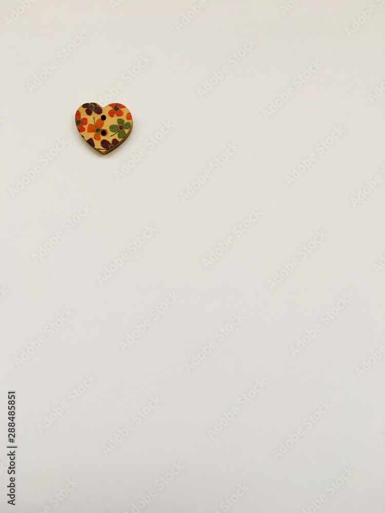 Single heart shaped button on a white background Single heart shaped button on a white background
