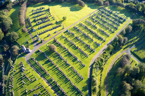 Vászonkép Graveyard necropolis with many headstones aerial view long shadows from gravesto