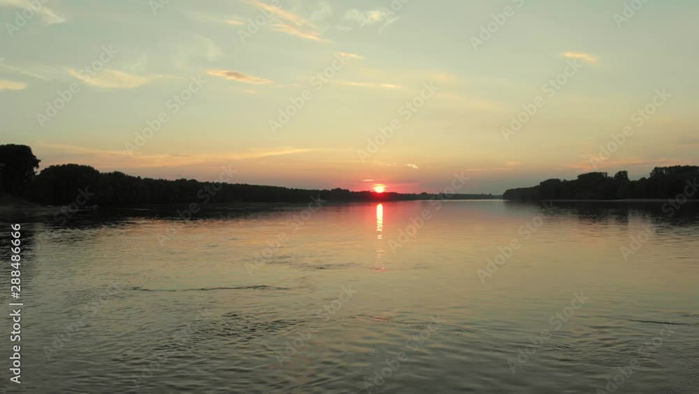 Aerial view of the sunset above the Danube river in Serbia, shots by a drone while flying above the river Aerial view of the sunset above the Danube river in Serbia, shots by a drone while flying above the river