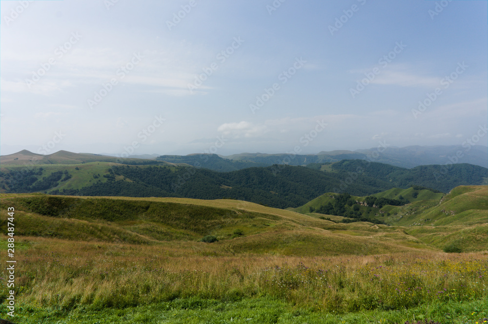 Gumbashi pass view in the russian caucasus, green meadow landscape at an altitude of above 2000 m