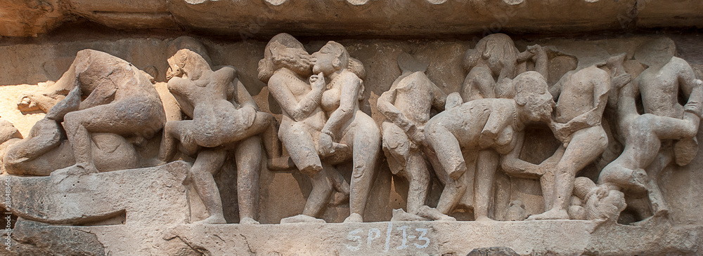 Erotic sculptures on the walls of famous Khajuraho Temples in India. Khajuraho Temples are one of the UNESCO World Heritage Sites in India. The temples are famous for their Nagara-style architectural