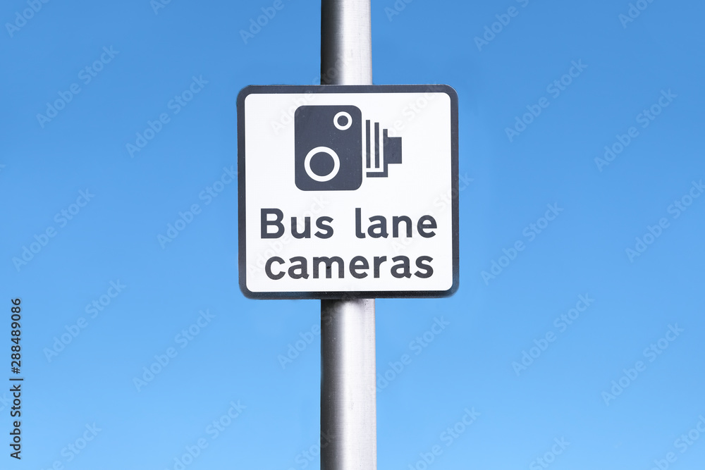 Bus lane camera symbol icon sign against blue sky at station in city Bus lane camera symbol icon sign against blue sky at station in city