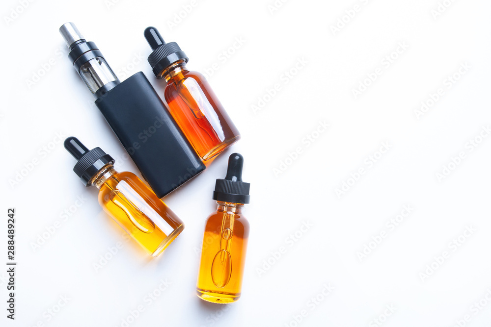 Electronic cigarette and liquids on white table. Place for inscription. VAPE smoking. The concept of vaping. Gadgets of vaper. Vaping shop. Electronic cigarette and liquids on white table. Place for inscription. VAPE smoking. The concept of vaping. Gadgets of vaper. Vaping shop.