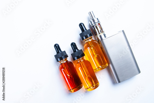 Smoking accessories on the white table. Smoking electronic cigarettes. The concept of VAPE. Vaping shop. Gadgets for vaping.