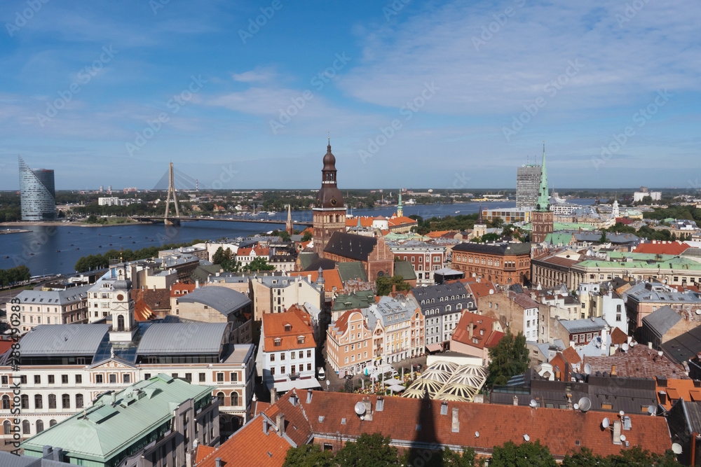 Riga, Latvia. Summer. Panoramic view of the city. The streets of the old city aerial view. River, houses, old churches, blue sky. Postcard. Free space for text.
