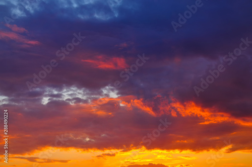 Sunset with clouds, in orange and purple shades