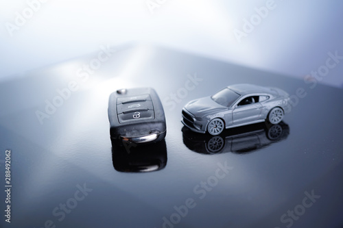 Car loan, Insurance, buy and sell and Auto Finance conceptual image with Car Key remote, die cast car and dollar bills  © MuhammadSyafiq