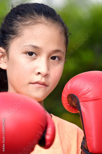 Unemotional Female Boxer Wearing Boxing Gloves © dtiberio