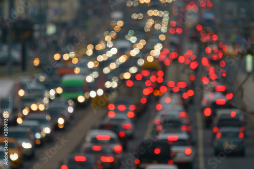 Blurred photography of cars motion. Big traffic in city. In the summer urban highway filled cars. Rush hours. To be late. Suitable for greeting card design, background, postcard template, poster © Yury and Tanya