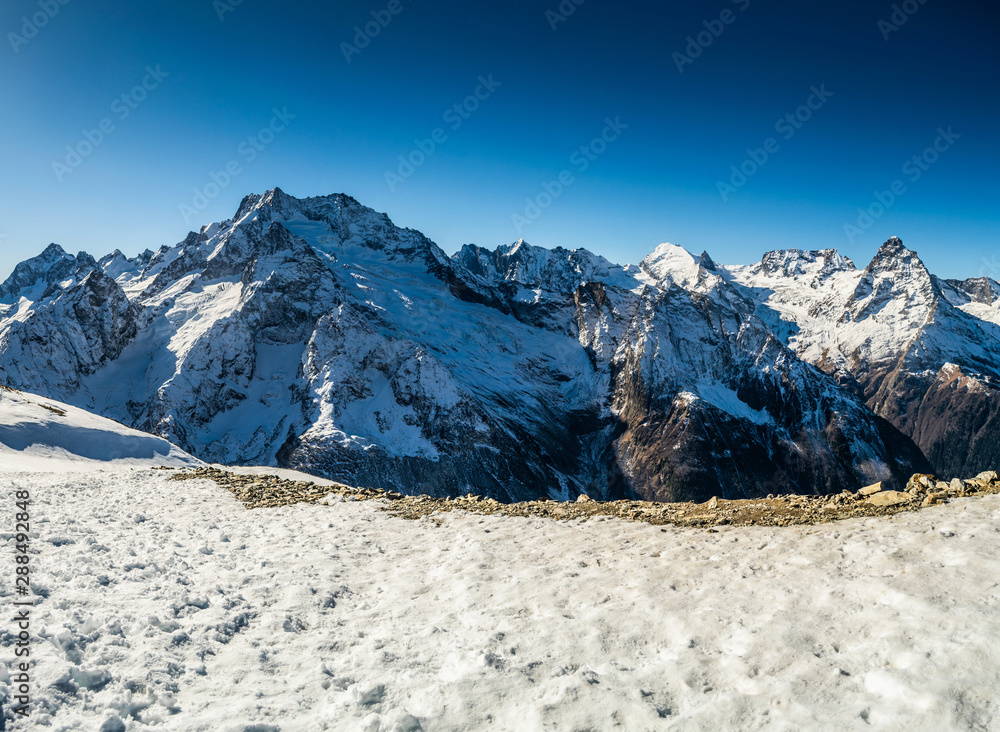 Gorgeous view on snow capped mountain range, Caucasus mountains near Dombay, Russia