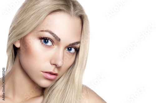 Portrait of young beautiful girl with long blond hair and natural make-up