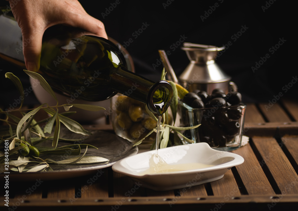 Glass bottle olives and falling oil Glass bottle olives and falling oil