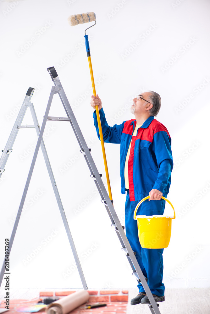 Old contractor doing renovation at home Old contractor doing renovation at home