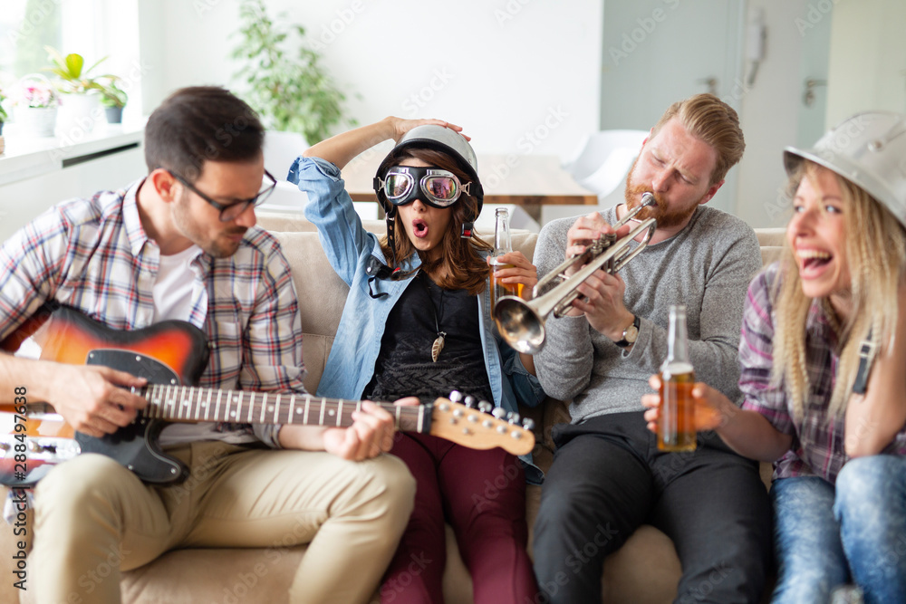 Friends having fun and partying in house and playing music Friends having fun and partying in house and playing music