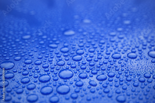 Closeup blue car paint surface with hydrophobic ceramic coating photo