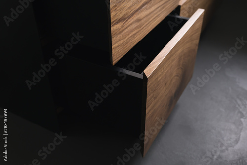 Fotografie Closeup details of modern tv stand made from walnut and powder coated steed