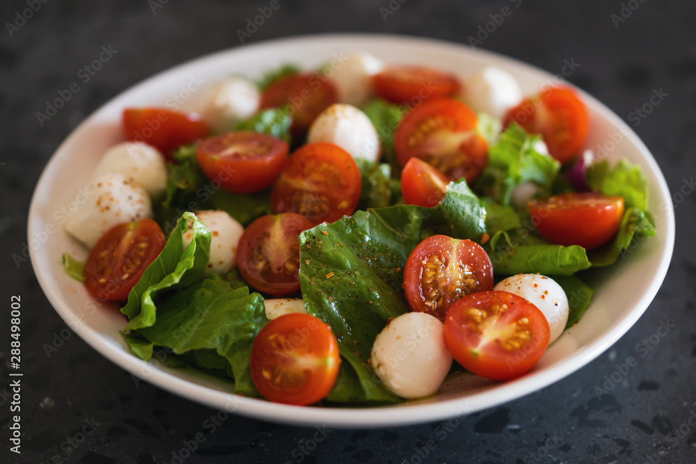 Salad with mozzarella balls tomatoes and mix salad