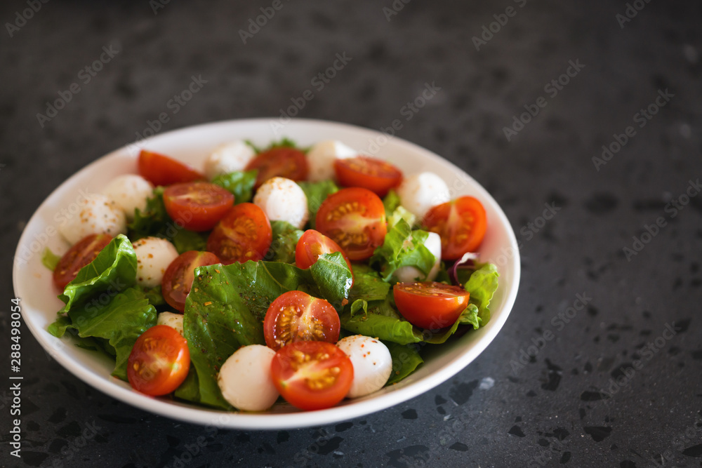 Salad with mozzarella balls tomatoes and mix salad Salad with mozzarella balls tomatoes and mix salad