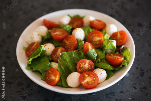 Salad with mozzarella balls tomatoes and mix salad