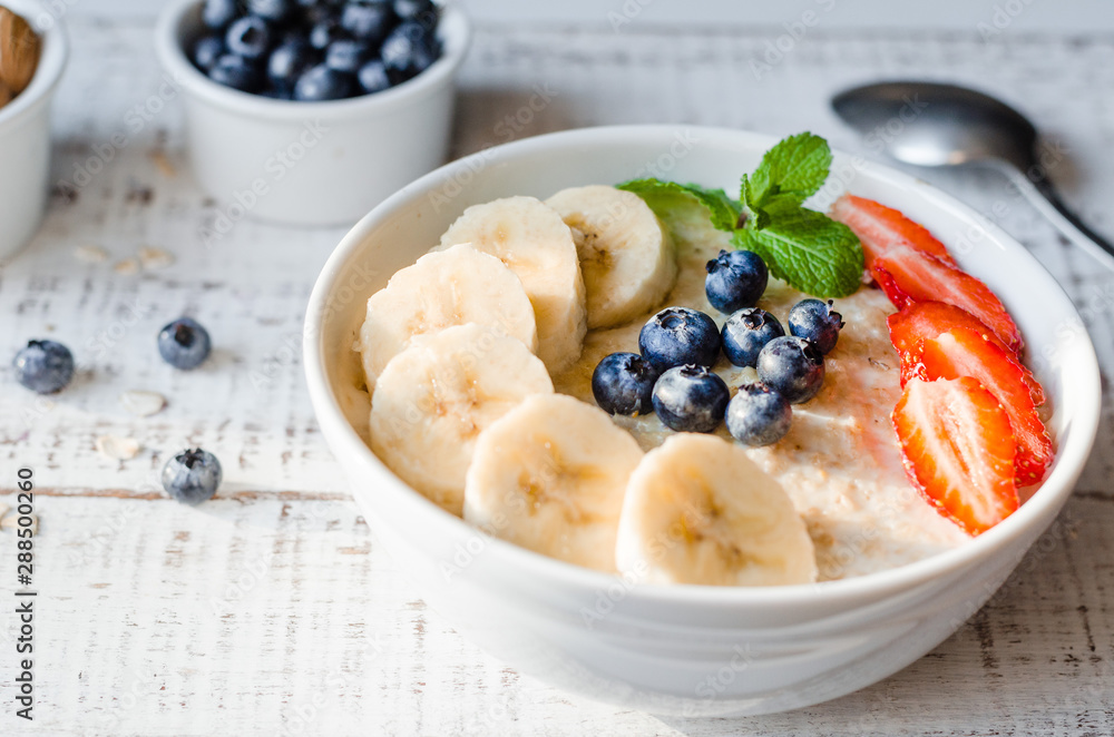 Oatmeal with bananas, strawberries, nuts and blueberries. Healthy breakfast. Oatmeal with bananas, strawberries, nuts and blueberries. Healthy breakfast.