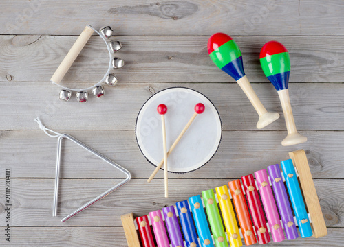 music accessories for children on wooden background. top view.