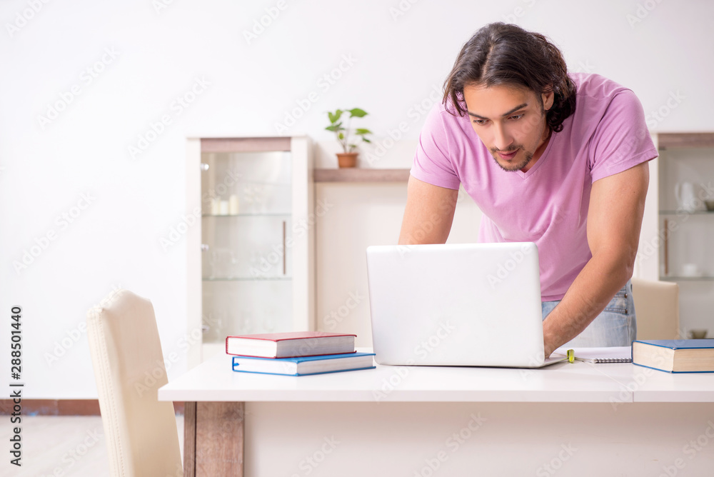 Young male student preparing for exams at home Young male student preparing for exams at home