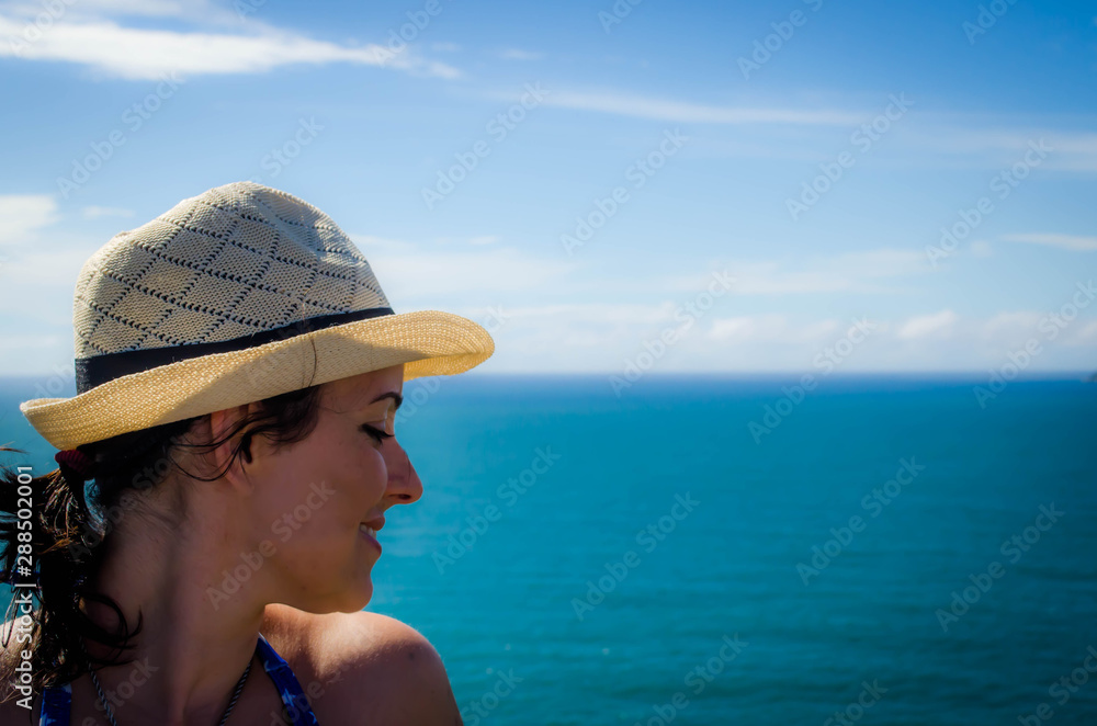 Woman on the beach whit hat 