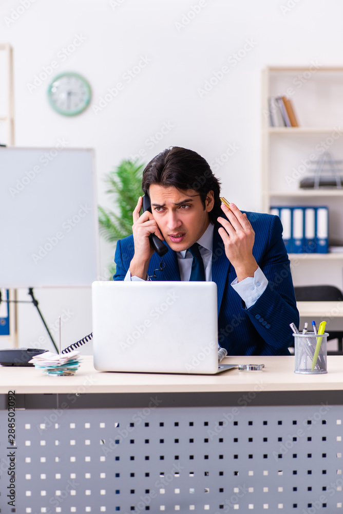 Young businessman sitting and working in the office Young businessman sitting and working in the office