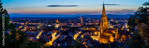 Germany, XXL panorama of city freiburg im breisgau from above in summer in magical twilight atmosphere after sunset