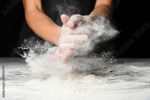 Hands of the cook splash clap with flour.