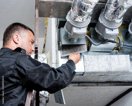 Ventilation cleaning. Specialist at work. Repair ventilation system (HVAC) photo