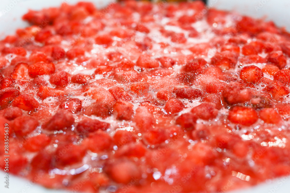 Strawberry jam cooking process. Organic traditional jam manufacturing., flat top view