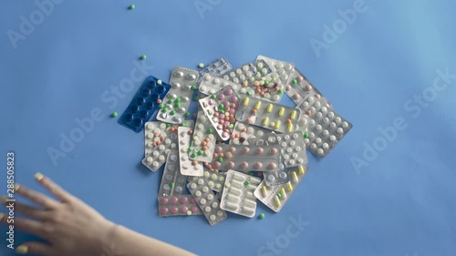 Wallpaper Mural Female hand whisking many Different Medication Pills off the table Torontodigital.ca
