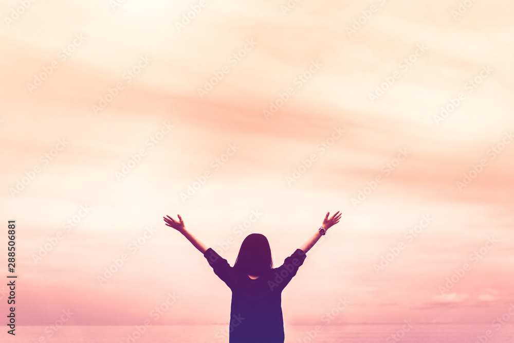Copy space of woman rise hand up on blue sky at tropical beach and island background.