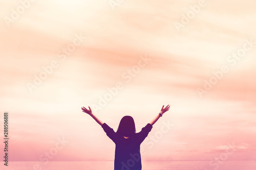 Copy space of woman rise hand up on blue sky at tropical beach and island background.