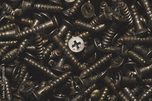 Screws background. heap of tapping screws. pile of fasteners