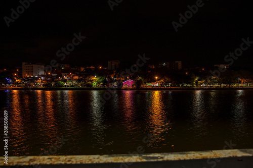 Christmas decoration lights reflected in lake at climate resort in Bragança Paulista region of lakes in Sao Paulo Brazil